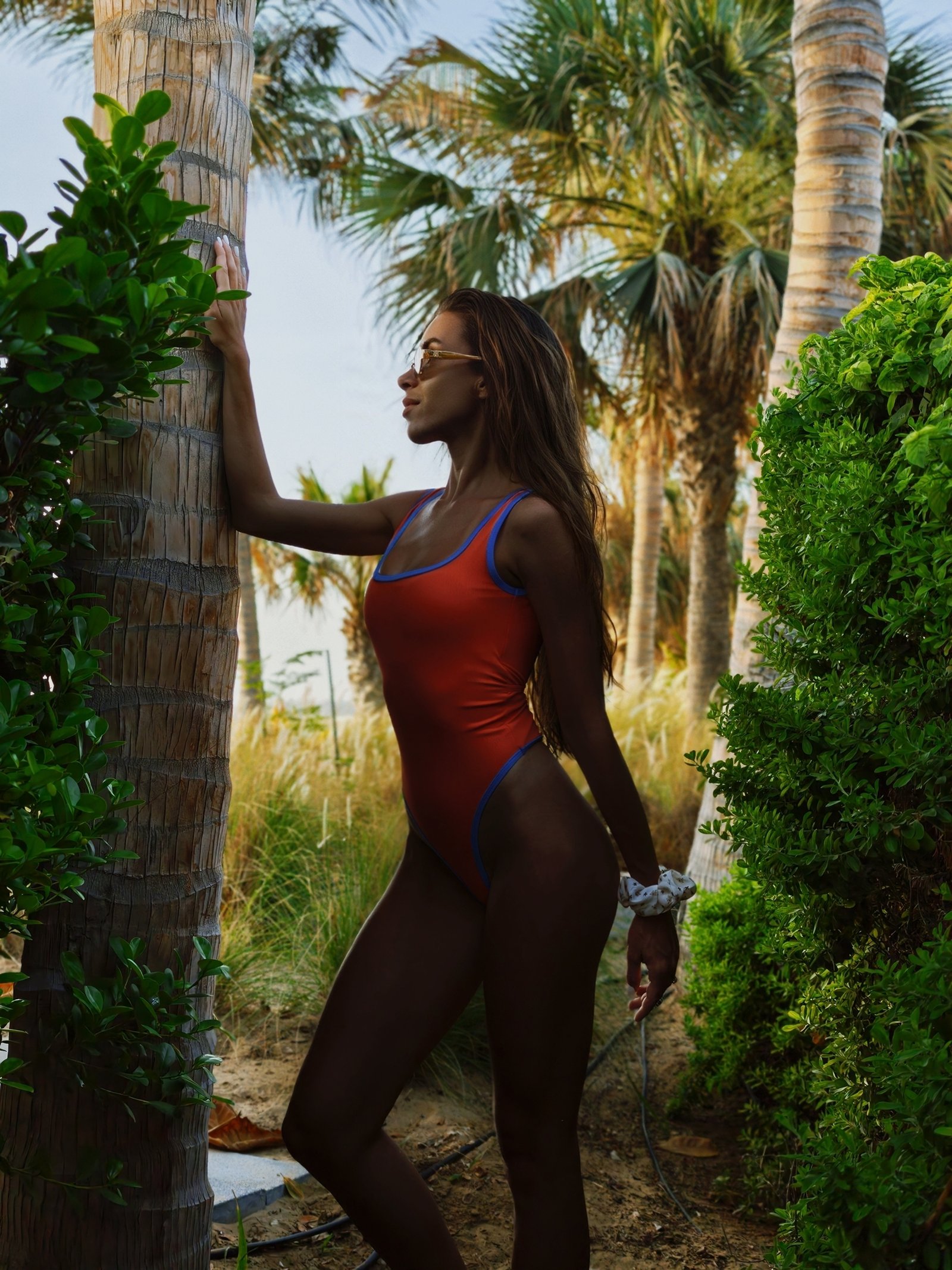Shetty Jamie 17 a woman in a swimsuit leaning against a tree